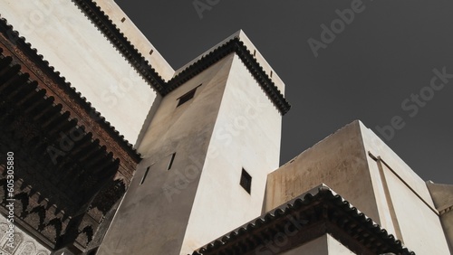 Low-angle shot of the upper building wall of Madrasa. Morocco.