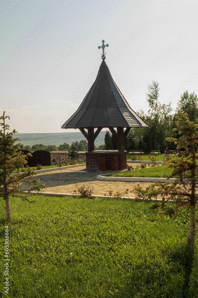 Small well with a cross on a sunny morning Small well with a cross on a sunny morning