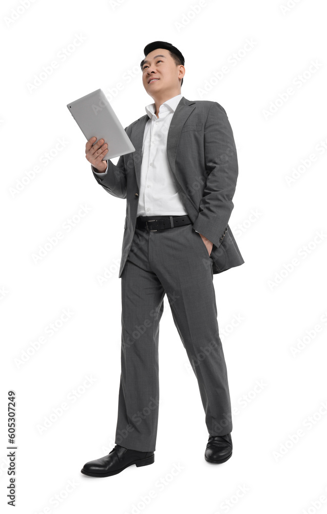 Businessman in suit with tablet on white background, low angle view Businessman in suit with tablet on white background, low angle view