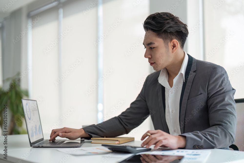 young business man look at laptop screen calculate expenses expenditures pay bills taxes online. male busy managing company budget, take care of financial paperwork young business man look at laptop screen calculate expenses expenditures pay bills taxes online. male busy managing company budget, take care of financial paperwork