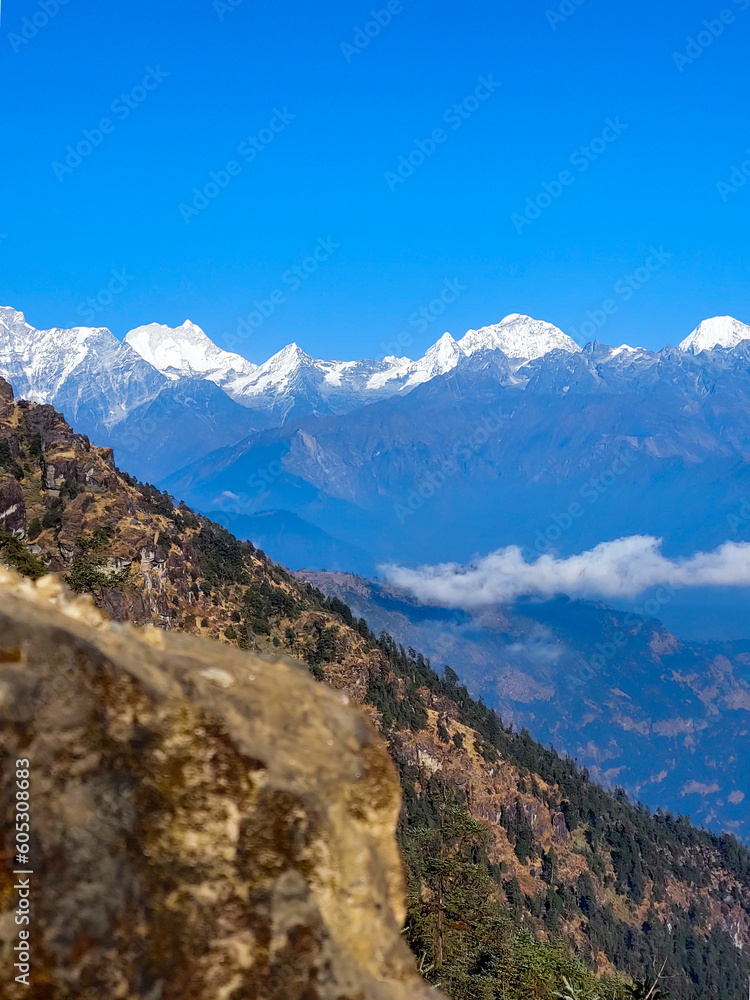 Amazing view of the snow capped mountains of the Himalayan range from kalinchowk province of Nepal with the hills and clouds around.