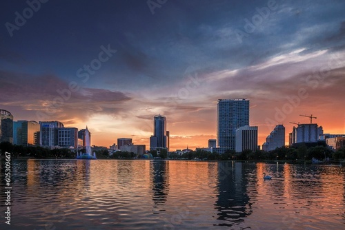 Orlando Florida Lake Eola cityscape with a sunset on the horizon © Kris Schmidt/Wirestock Creators