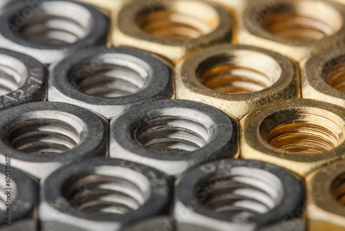 Metallic hex nuts layed out in a hexagonal pattern
