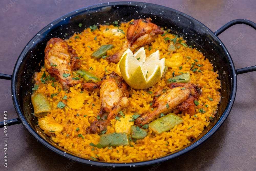Closeup of Paella served on a pan in a restaurant