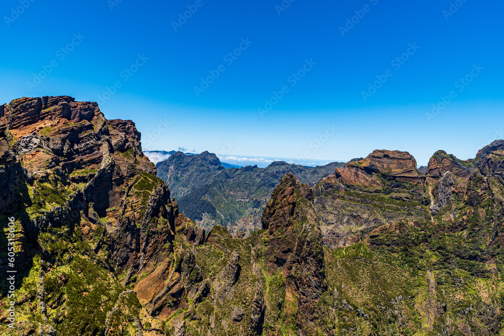 Wild mountains of Madeira - view from Vereda do Areeiro hiking trail between Pico Ruivo and Pico do Areeiro hills Wild mountains of Madeira - view from Vereda do Areeiro hiking trail between Pico Ruivo and Pico do Areeiro hills