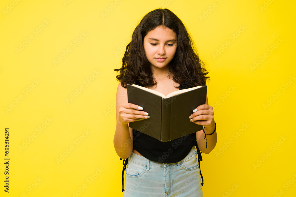 Thirteen year old teen girl reading a book Thirteen year old teen girl reading a book