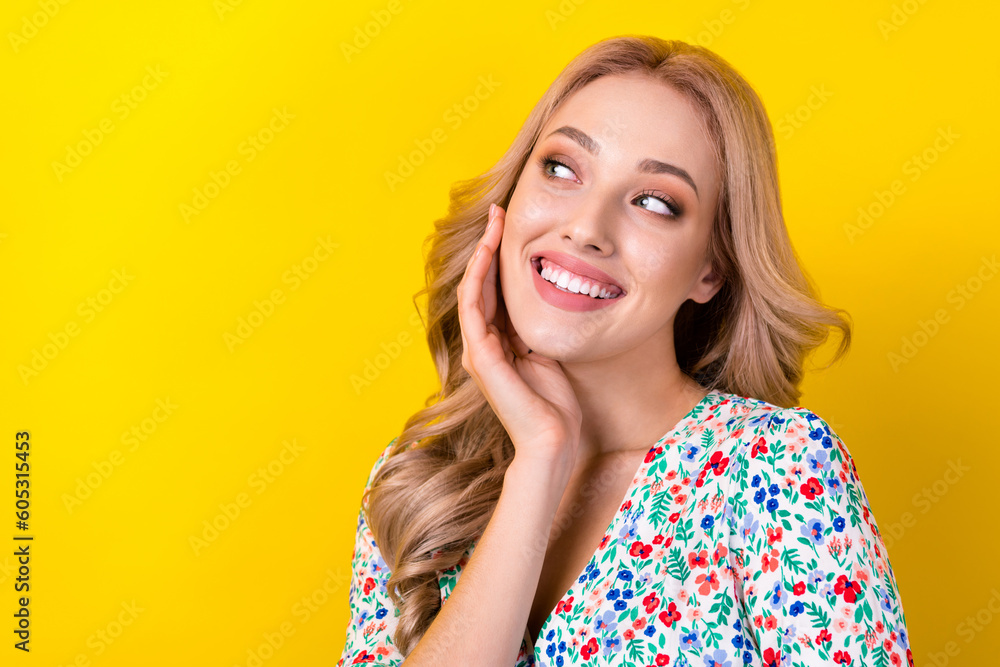 Fototapeta premium Photo of dreamy pretty lady wear flower print dress arm cheek looking empty space isolated yellow color background