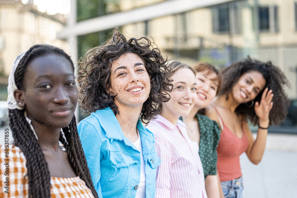 Five young teenager in a row, focus on brunette girl with freckles