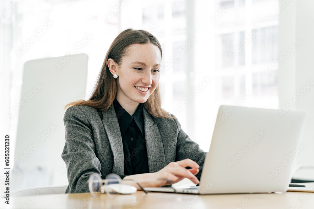 A freelancer student is a young woman working in an office, online learning education remotely, using a laptop in the workplace. A freelancer student is a young woman working in an office, online learning education remotely, using a laptop in the workplace.