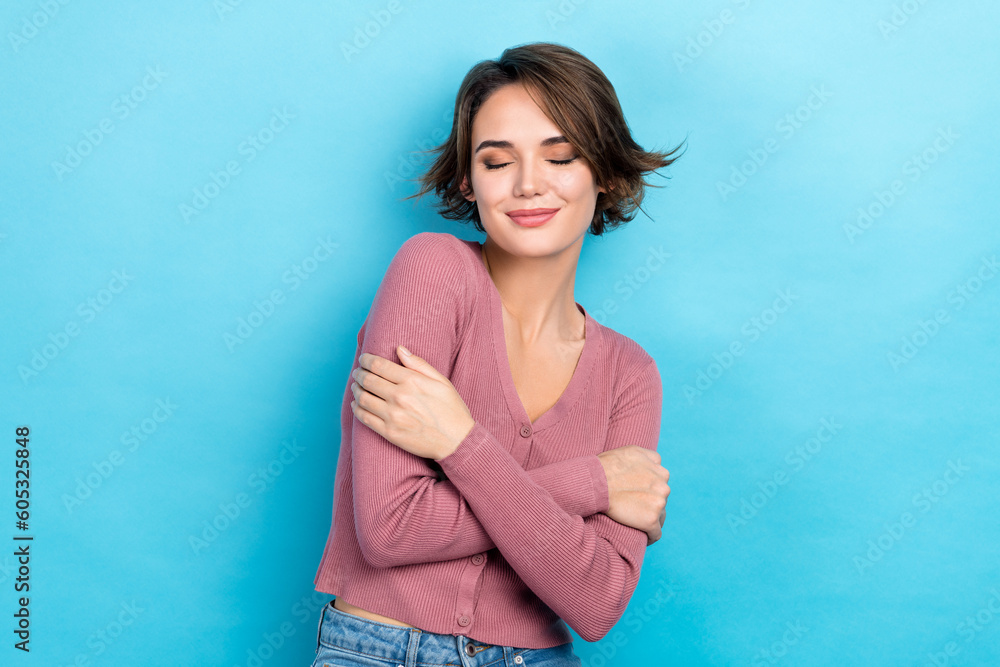 Photo of adorable lady hugging herself close eyes overjoyed wear pink trendy casual shirt outfit isolated blue color background - obrazy, fototapety, plakaty 