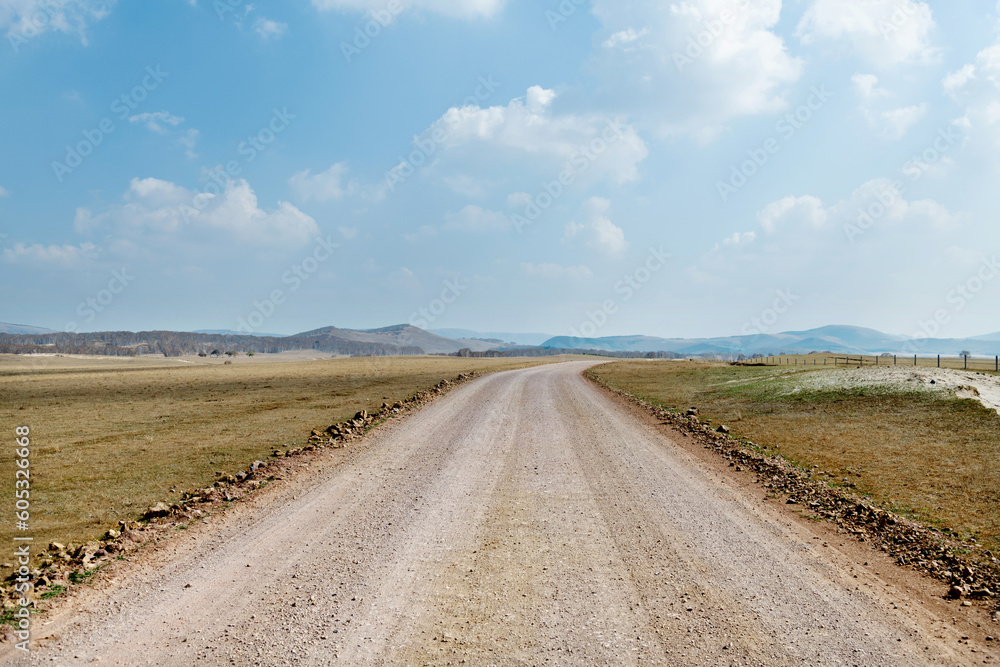 A dirt road through the field A dirt road through the field