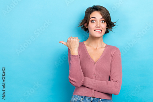 Photo of excited lady shop assistant direct thumb finger empty space low price wear pink shirt isolated blue color background