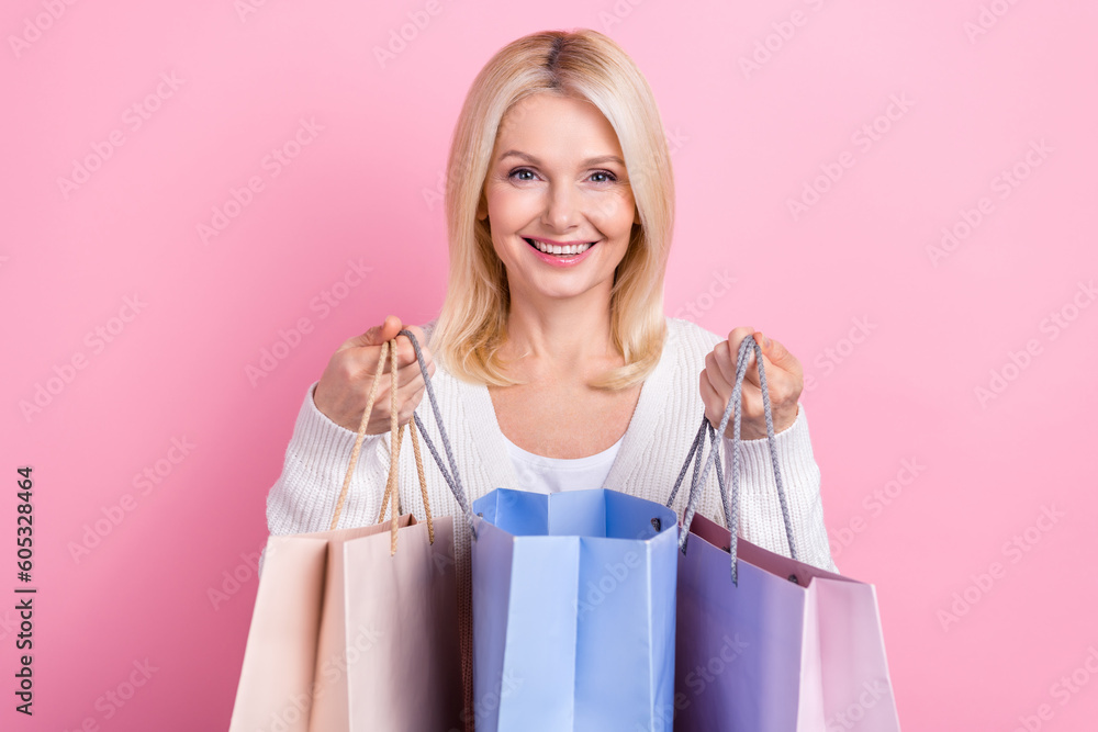 Photo of sweet shiny lady wear white cardigan smiling open shopping packages isolated pink color background