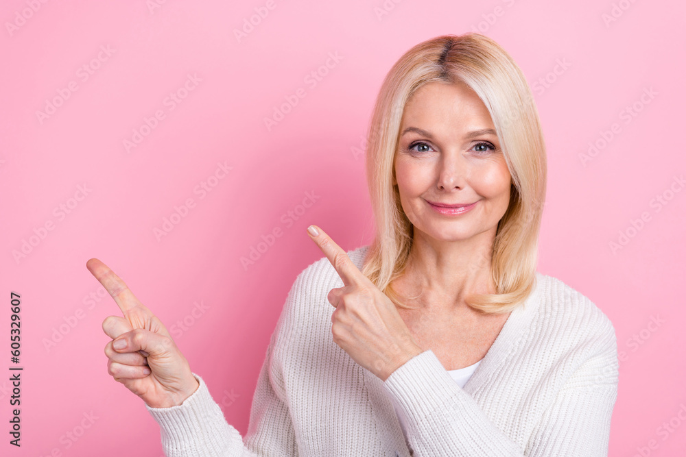 Portrait of satisfied funny person with blond hair wear white sweater indicating empty space proposition isolated on pink color background Portrait of satisfied funny person with blond hair wear white sweater indicating empty space proposition isolated on pink color background