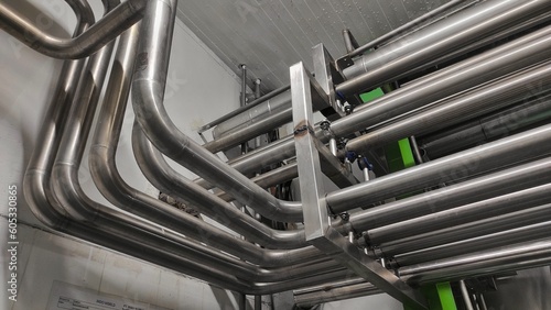 Stainless steel pipes in production room of factory