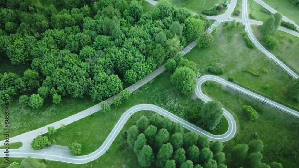 Curvy bike path. Laid between the trees in the park. Drone photography, aerial photography. Curvy bike path. Laid between the trees in the park. Drone photography, aerial photography.