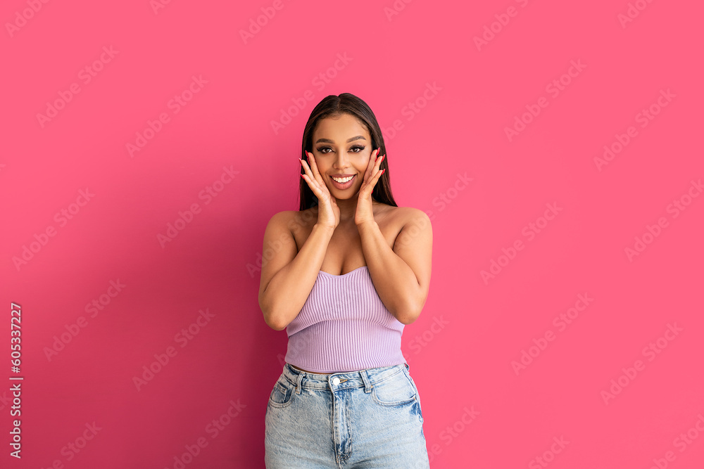 Joyful woman smiling, looking at the camera, posing on a pastel pink Studio Background. Real people emotions, toothy smile. Joyful woman smiling, looking at the camera, posing on a pastel pink Studio Background. Real people emotions, toothy smile.