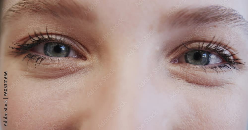Close up of the blue eyes of a smiling caucasian female nurse, in slow motion Close up of the blue eyes of a smiling caucasian female nurse, in slow motion