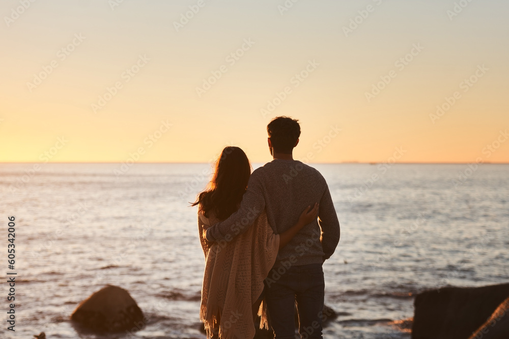 Hug, sunset and couple relax on beach in evening on holiday, summer vacation and weekend by ocean. Nature, love and man and woman embrace, hugging and calm for bonding, quality time and peace by sea