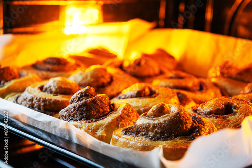 Process of cinnamon buns baking on the baking pan in the oven