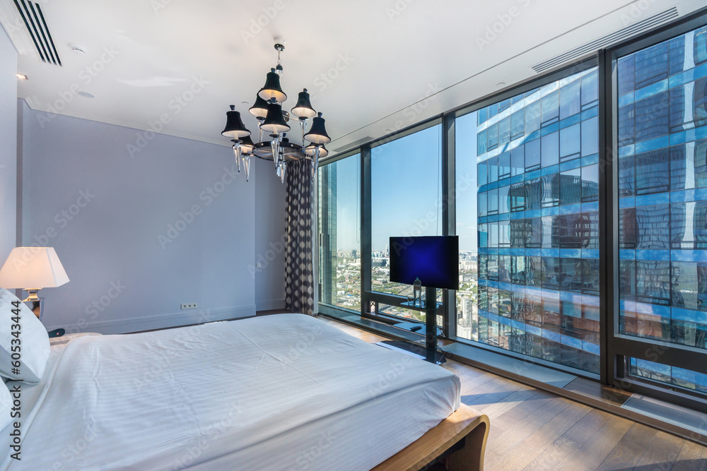 Ταπετσαρία Modern bedroom interior design for home, hotel, interior details, a wide bed on the background of a panoramic window with a delightful view of the city
