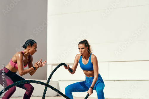 Canvas Print Woman, personal trainer and battle rope for exercise, workout or training in fitness outdoors