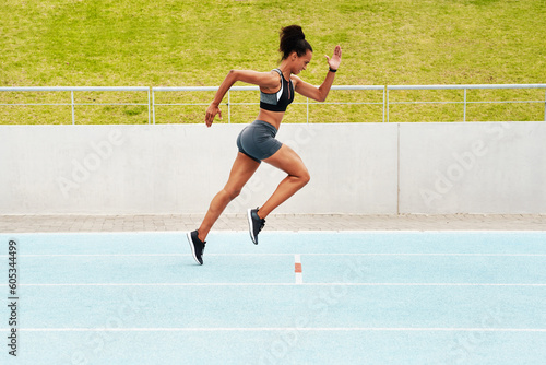 Woman, cardio and running on track in training, physical exercise or workout on stadium. Active, fit or sporty female person, athlete or runner in sports run, race or competition for healthy wellness © Emil Lime/peopleimages.com