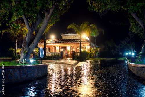 Night view of an old-fashioned Spanish house with yellow lantern