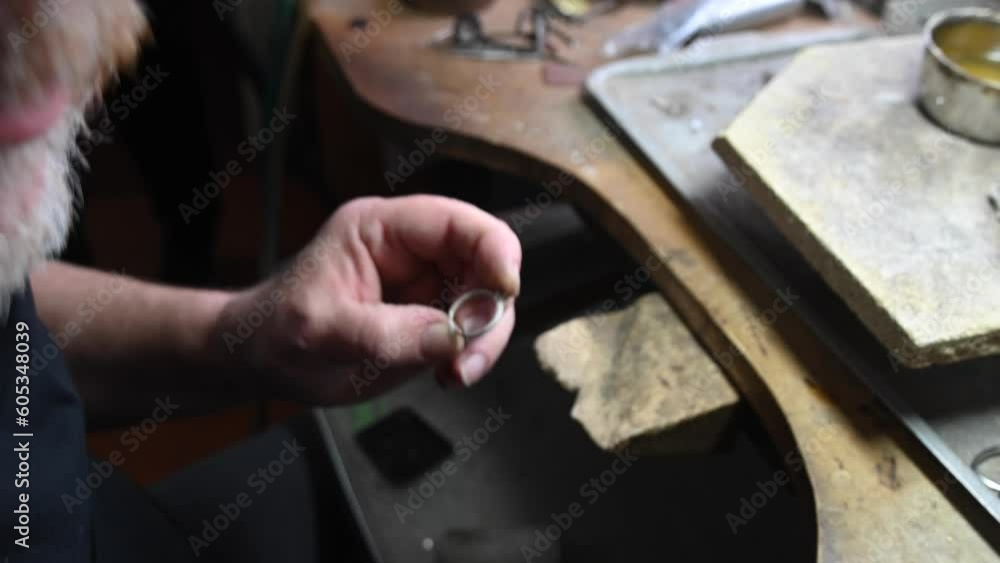 Gold wedding ring craft by goldsmith, isolated. Macro video. Craft jewelry making with professional tools. Process of ring polishing making handmade. 4k raw slow motion video Gold wedding ring craft by goldsmith, isolated. Macro video. Craft jewelry making with professional tools. Process of ring polishing making handmade. 4k raw slow motion video
