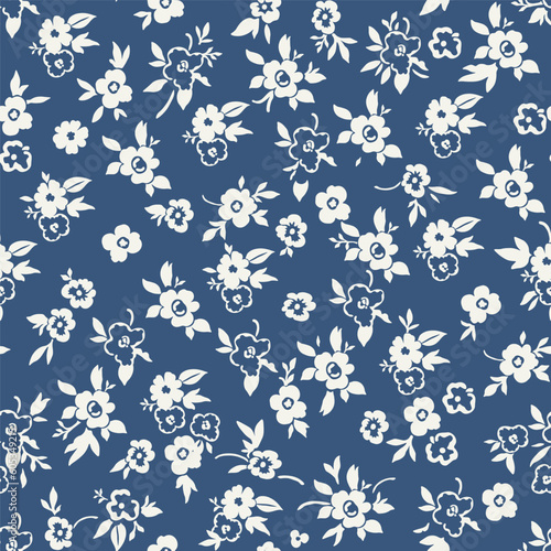 Cute floral pattern in a small flower. Seamless vector texture. An elegant template for fashionable prints. Print with small white and blue flowers. Blue background. Stock print.