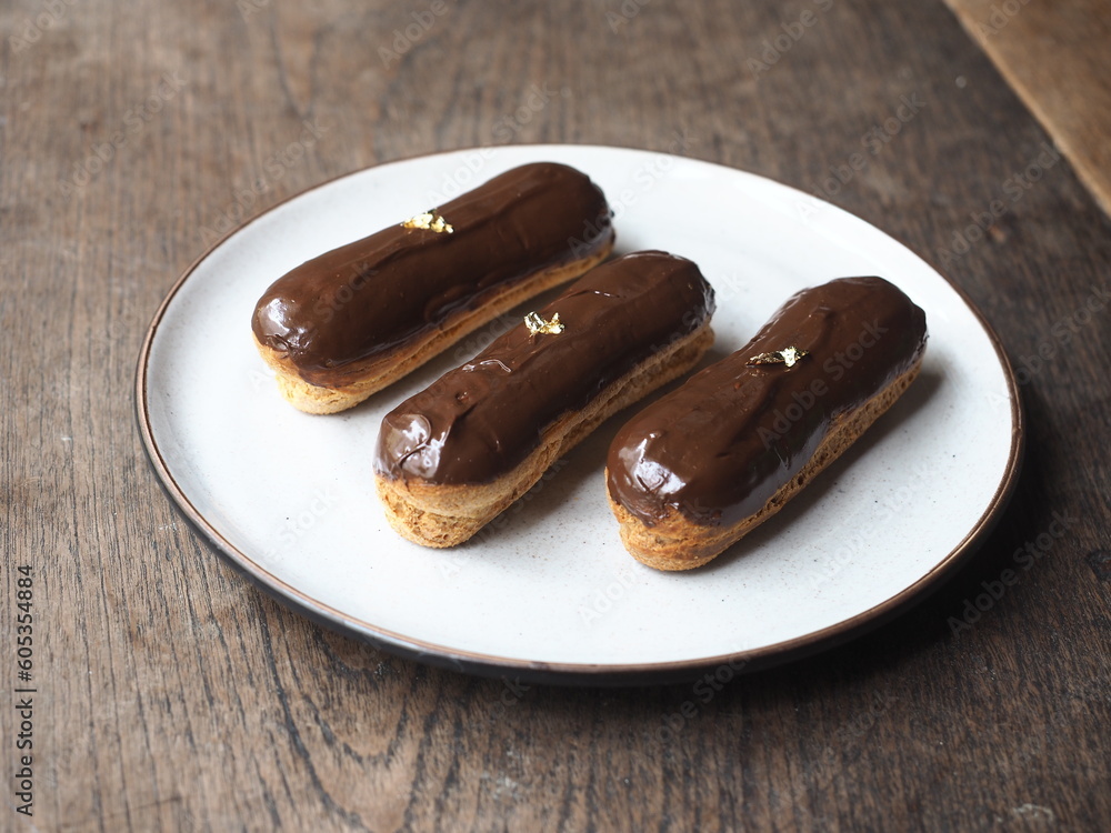 eclairs with chocolate glaze and gold leaf eclairs with chocolate glaze and gold leaf