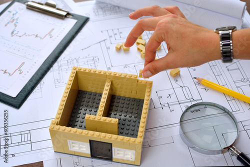 Architect working on blueprint. Architects workplace - architectural project, blueprints, laptop and divider compass, pencil. Construction concept. Engineering tools
