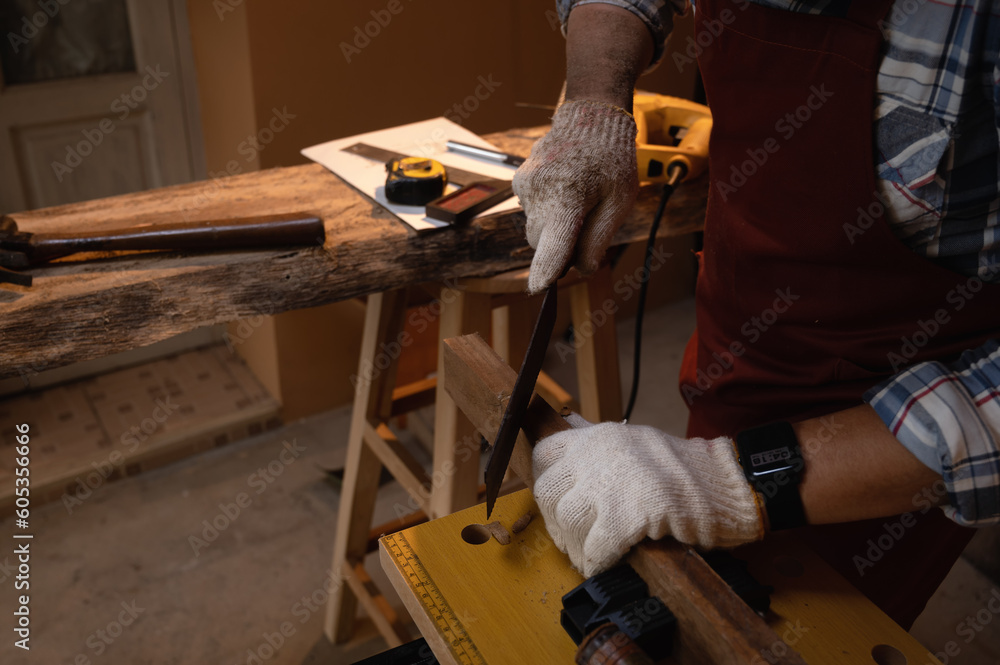 Hand saw cutting manual wood, Close-up cutting wood, Selective focus on saw blade equipment while working.