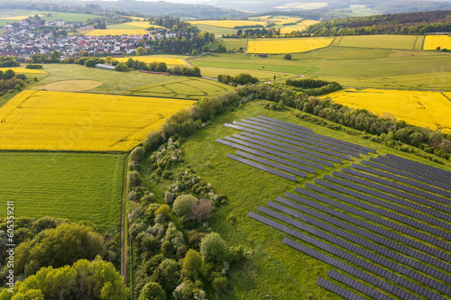 Aerial view of flowering rapeseed fields and solar panels in the Taunus near Taunusstein - Germany near Wiesbaden