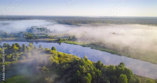 Aerial video of beautiful foggy sunrise over a small forest river