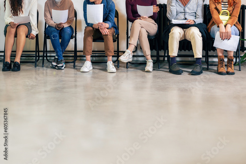 Group of young business people sitting in chairs and waiting for an interview