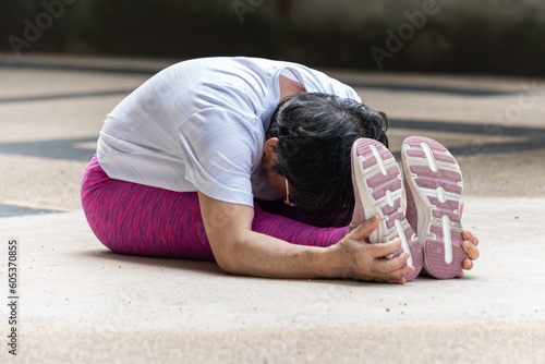 late age woman attractive white and pink sportswear practicing and exercise in yoga style outdoor pose yoga lesson.
