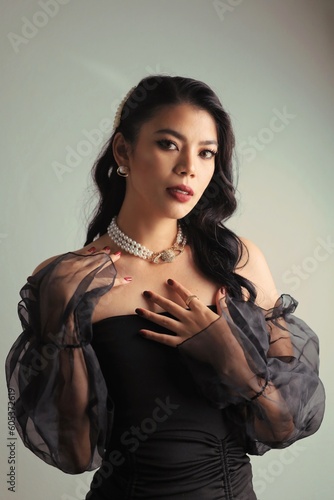 Beautiful woman long black curly hair in black dress retro vintage style, Portrait Beautiful model with makeup red lip vintage style.