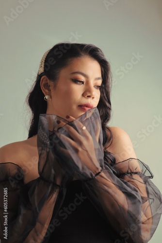 Beautiful woman long black curly hair in black dress retro vintage style, Portrait Beautiful model with makeup red lip vintage style.