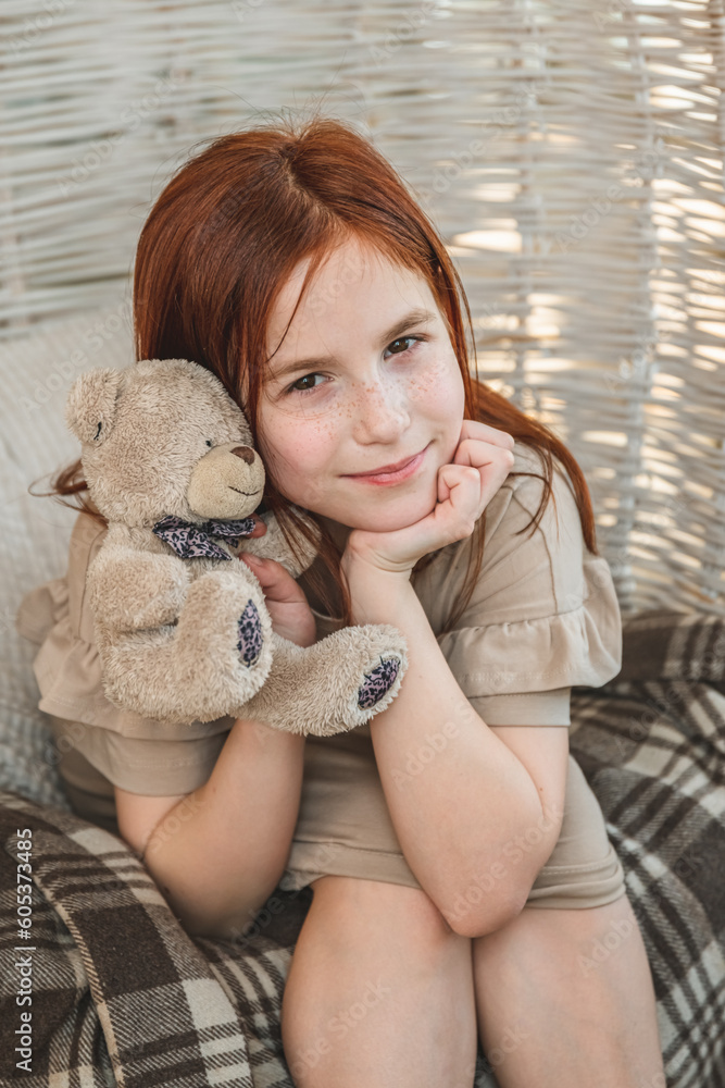 Cute girl with a teddy bear in her hands looking at the camera and smiling Cute girl with a teddy bear in her hands looking at the camera and smiling