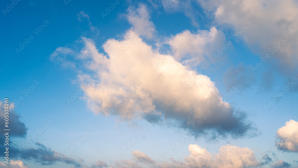 Naklejka premium Beautiful view of blue sky with clouds. Beautiful shapes, partly cloudy. Colorful sunset. Natural sky background texture, beautiful color.