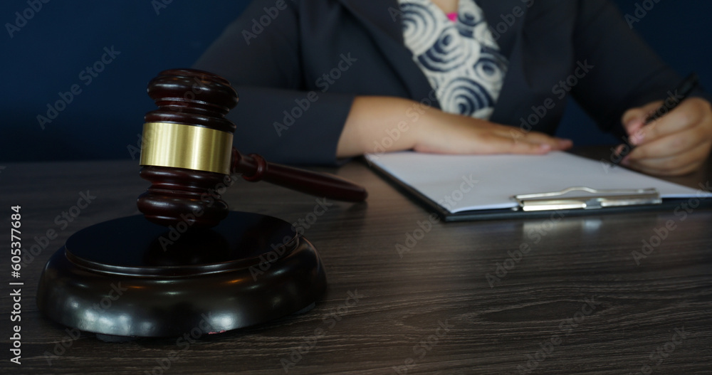 Legal counsel presents to the client a signed contract with gavel and legal law. Justice and lawyer law of advisor Concepts Legal counsel presents to the client a signed contract with gavel and legal law. Justice and lawyer law of advisor Concepts