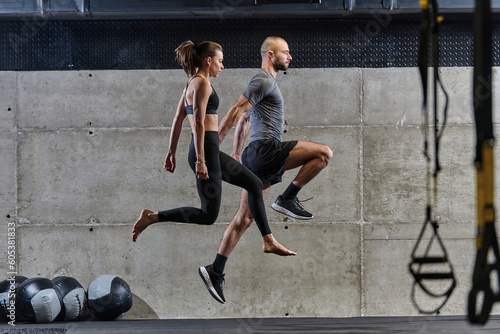 A fit couple exercising various types of jumps in a modern gym, demonstrating their physical fitness, strength, and athletic performance