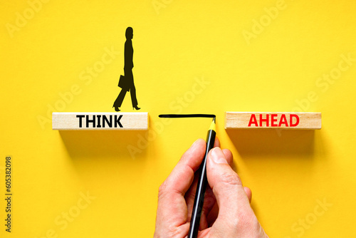 Think ahead symbol. Concept words Think ahead on wooden blocks on beautiful yellow table yellow background. Businessman hand. Business support motivation psychological think ahead concept. Copy space