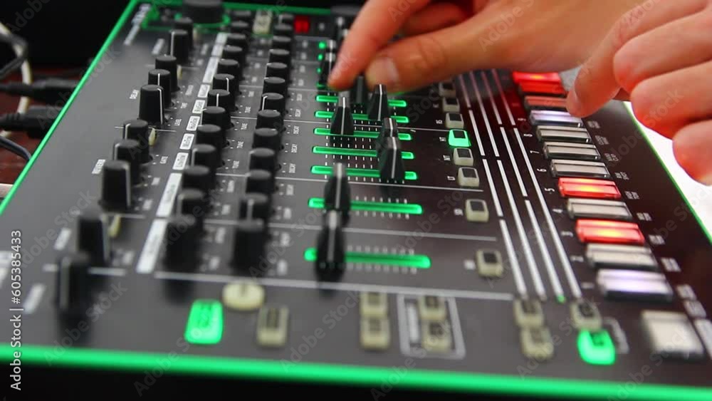 DJ's hands play on the remote, moving the sliders DJ's hands play on the remote, moving the sliders