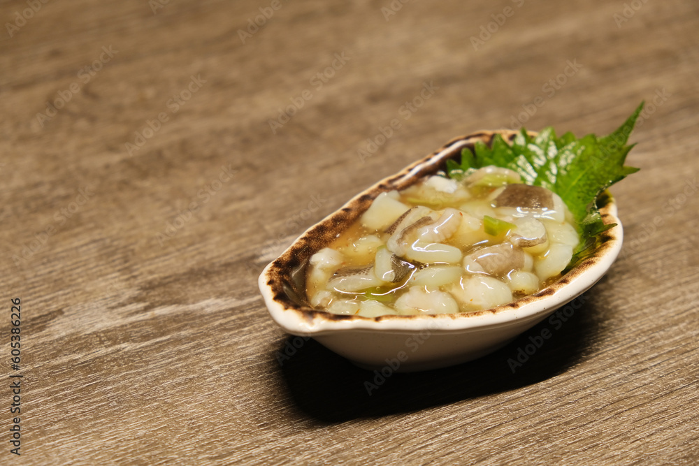 close up a plate of Tako Wasabi (Octopus and Wasabi) on wooden table. Octopus appetizer in Japan close up a plate of Tako Wasabi (Octopus and Wasabi) on wooden table. Octopus appetizer in Japan
