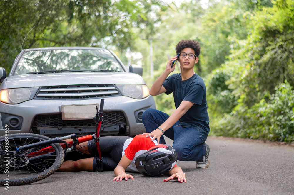 Car accident with MTB mountain biker: Young Asian man crashes into cyclist seriously injured, driver rushes down to see the injured and call an ambulance, Young man stressed from driving Crash people. Car accident with MTB mountain biker: Young Asian man crashes into cyclist seriously injured, driver rushes down to see the injured and call an ambulance, Young man stressed from driving Crash people.