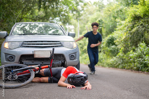 Car accident with MTB mountain bike rider and first aid : Young Asian man driving a car crashes into a cyclist falls and injured his knee, first aid to a cyclist who is injured by being hit. car crash © VR Studio