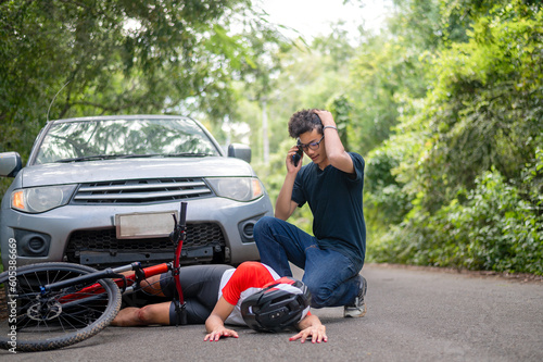 Car accident with MTB mountain biker: Young Asian man crashes into cyclist seriously injured, driver rushes down to see the injured and call an ambulance, Young man stressed from driving Crash people. © VR Studio
