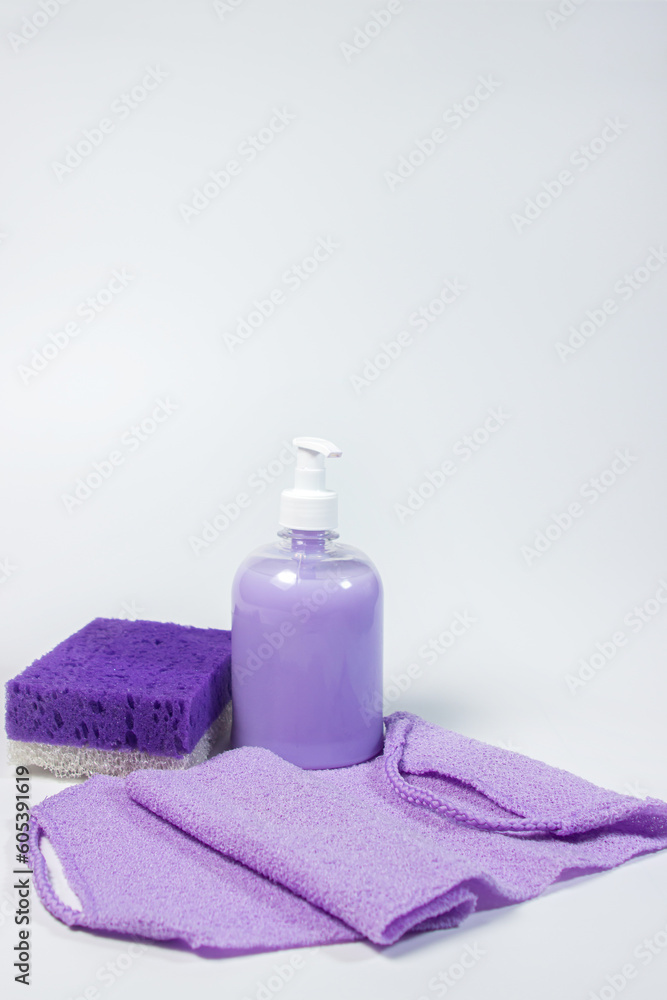 Liquid soap, bath sponge and washcloth on a white background. Hygiene product.